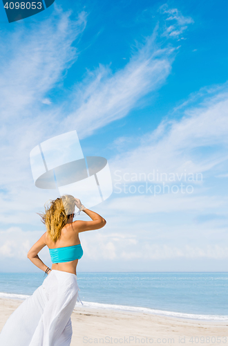 Image of portrait of young pretty woman looking to the ocean 