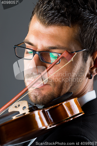 Image of Musician with violin on dark background