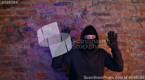 Image of Caught burglar standing near wall