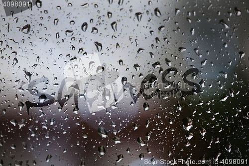 Image of Sadness written on rainy window