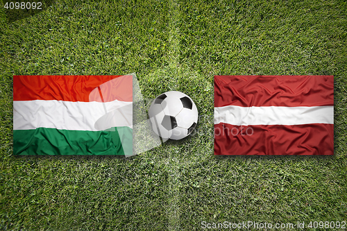 Image of Hungary vs. Latvia flags on soccer field