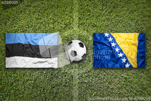 Image of Estonia vs. Bosnia and Herzegovina flags on soccer field