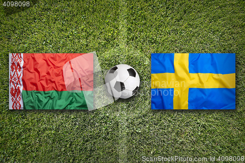 Image of Belarus vs. Sweden flags on soccer field