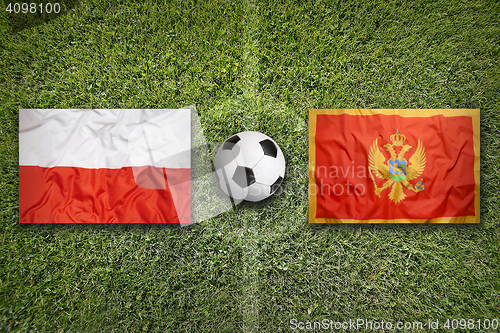 Image of Poland vs. Montenegro flags on soccer field