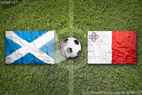 Image of Scotland vs. Malta flags on soccer field