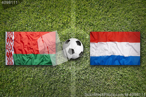 Image of Belarus vs. Netherlands flags on soccer field