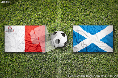 Image of Malta vs. Scotland flags on soccer field