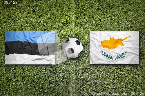 Image of Estonia vs. Cyprus flags on soccer field