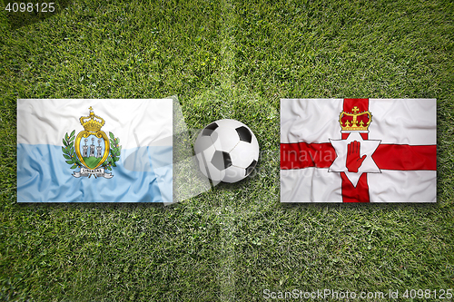 Image of San Marino vs. Northern Ireland flags on soccer field