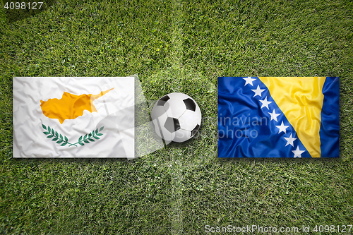 Image of Cyprus vs. Bosnia and Herzegovina flags on soccer field