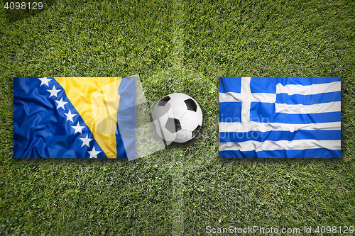 Image of Bosnia and Herzegovina vs. Greece flags on soccer field