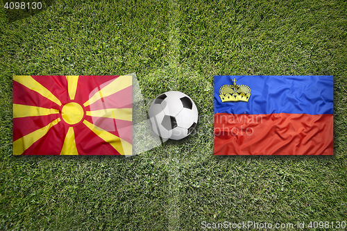 Image of Liechtenstein vs. Macedonia flags on soccer field