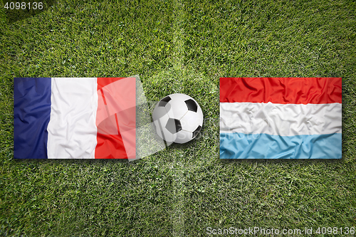 Image of France vs. Luxembourg flags on soccer field