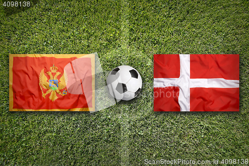 Image of Montenegro vs. Denmark flags on soccer field