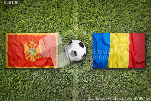 Image of Montenegro vs. Romania flags on soccer field