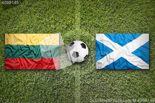 Image of Lithuania vs. Scotland flags on soccer field