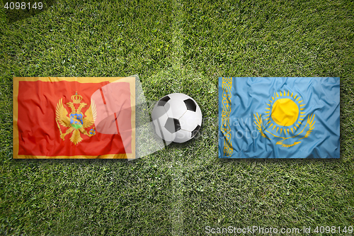 Image of Montenegro vs. Kazakhstan flags on soccer field
