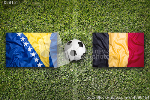 Image of Bosnia and Herzegovina vs. Belgium flags on soccer field