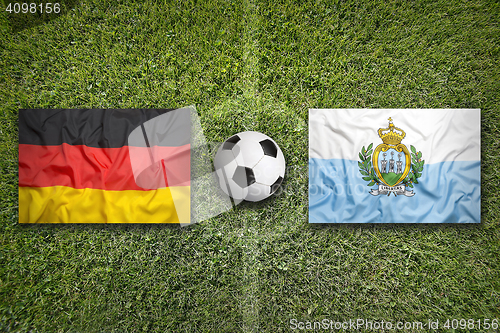 Image of Germany vs. San Marino flags on soccer field