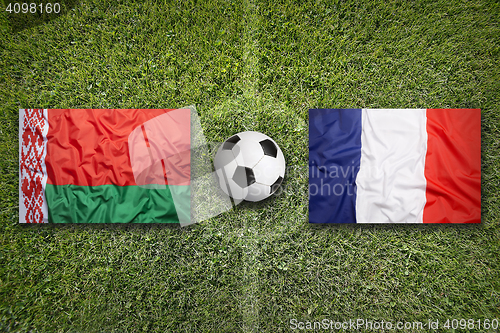 Image of Belarus vs. France flags on soccer field