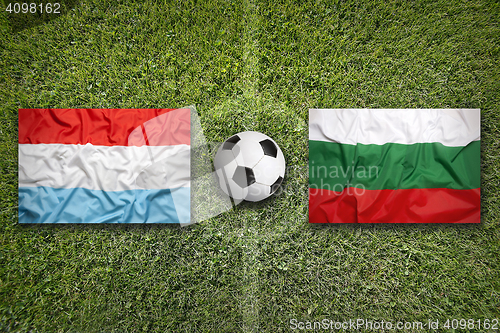 Image of Luxembourg vs. Bulgaria flags on soccer field