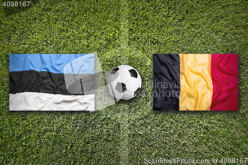 Image of Estonia vs. Belgium flags on soccer field