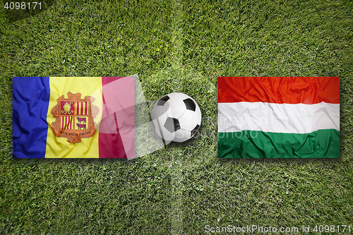 Image of Andorra vs. Hungary flags on soccer field