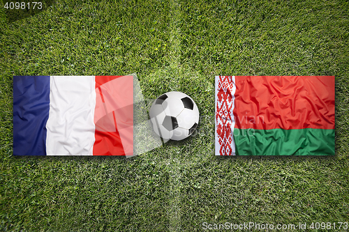 Image of France vs. Belarus flags on soccer field