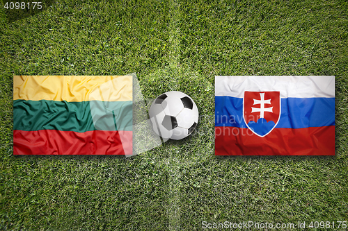 Image of Lithuania vs. Slovakia flags on soccer field