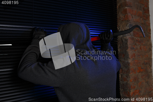 Image of Night burglar trying open door