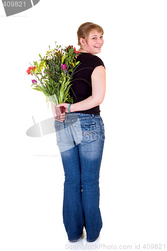 Image of Happy smiling young girl presenting flowers