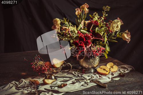 Image of Still life with apples and autumn flowers