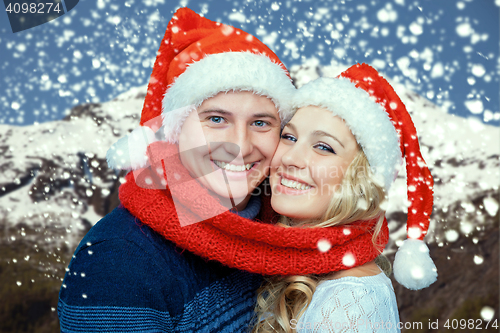 Image of Lovely christmas couple in Santa Claus hats