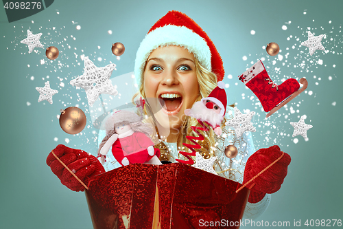Image of Beautiful young woman in Santa Claus clothes