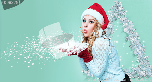 Image of Beautiful young woman in Santa Claus clothes with snowflakes