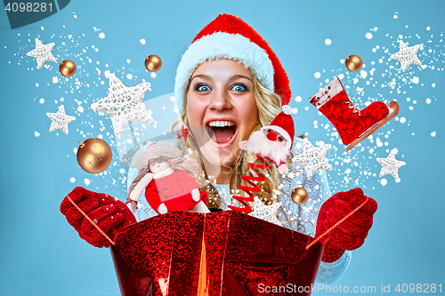 Image of Beautiful young woman in Santa Claus clothes