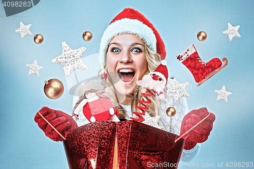 Image of Beautiful young woman in Santa Claus clothes