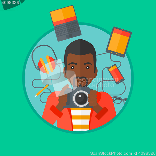 Image of Young man surrounded with his gadgets.