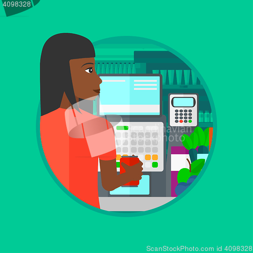 Image of Cashier standing at the checkout in supermarket.