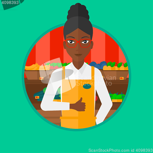 Image of Friendly supermarket worker giving thumb.