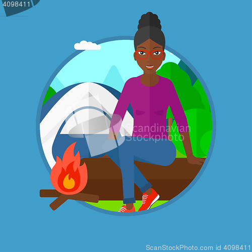 Image of Woman sitting on log in the camping.