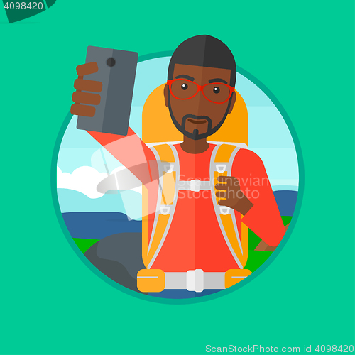 Image of Tourist with backpack making selfie.