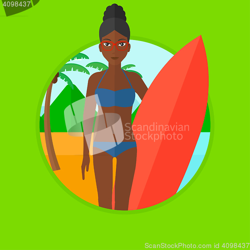 Image of Surfer with surfboard on the beach.