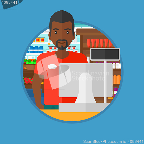 Image of Cashier standing at the checkout in supermarket.