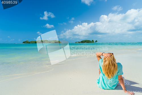 Image of portrait of young pretty woman looking to the ocean 