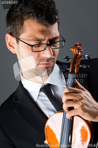 Image of Musician with violin on dark background