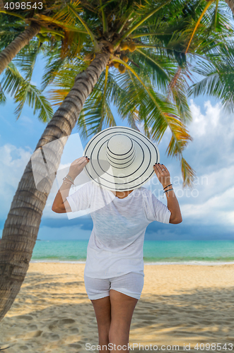 Image of portrait of young pretty woman looking to the ocean 