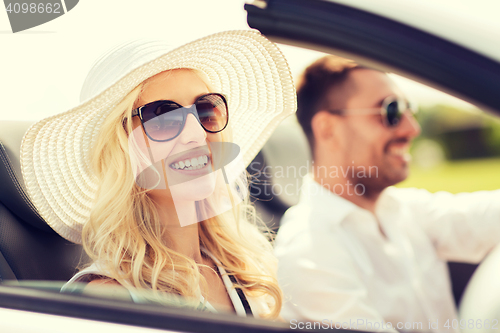Image of happy man and woman driving in cabriolet car