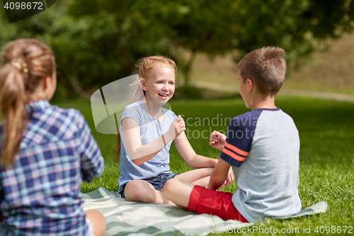 Image of happy kids playing rock-paper-scissors game