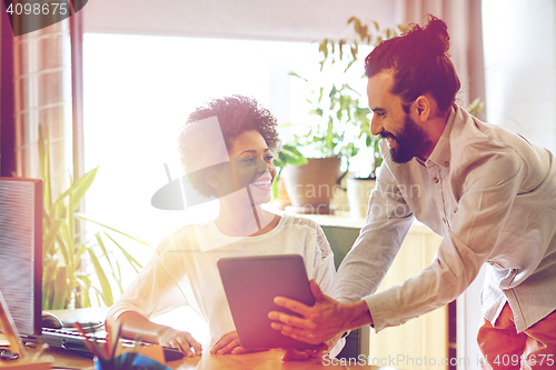 Image of happy creative team with tablet pc in office